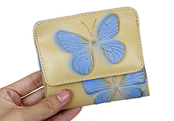 コンパクトな蝶の型押し二つ折り財布（牛革/日本製）繊細に表現された蝶の型押しは、製品ごとにひとつひとつ違う位置や大きさで現れます。