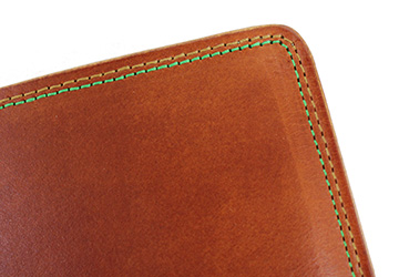 ２色のステッチが彩り鮮やかな二つ折り財布（牛革/日本製）等間隔の美しいステッチは、卓越したミシン技術を要する職人のみがなせる技です。
一周ずつ丁寧に縫われています。
